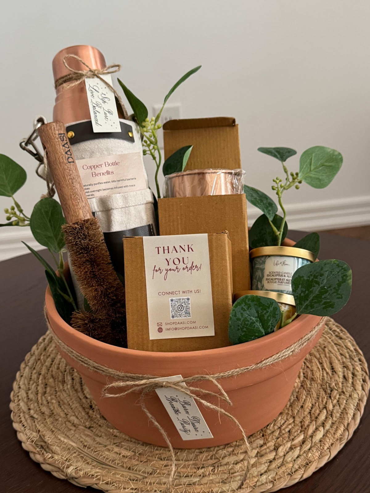 The Ritual Hamper corporate gift set — copper bottle, coir brush, and candle in a terracotta gift pot
